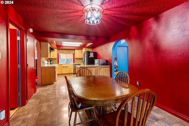 dining area with a textured ceiling and sink