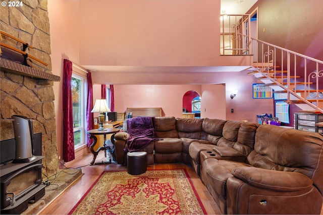 living room with wood-type flooring and a high ceiling