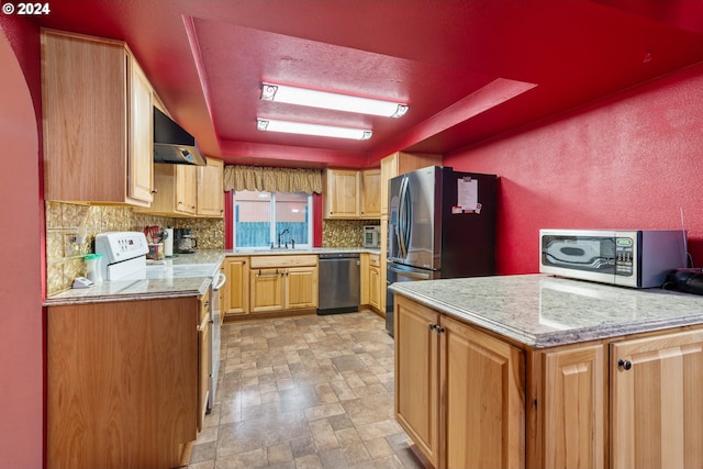 kitchen featuring sink, stainless steel appliances, a raised ceiling, backsplash, and exhaust hood