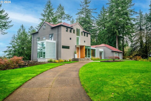 contemporary home with a front lawn