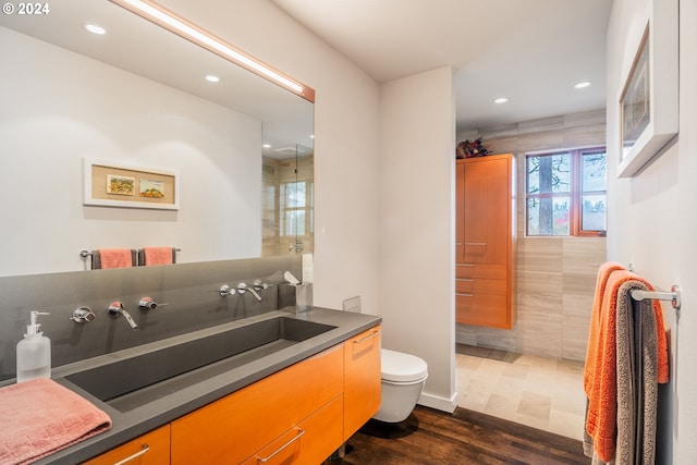 bathroom featuring hardwood / wood-style flooring, vanity, and toilet