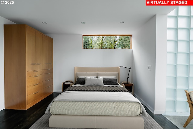 bedroom with dark wood-type flooring