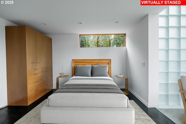 bedroom featuring baseboards, dark wood-style floors, and recessed lighting