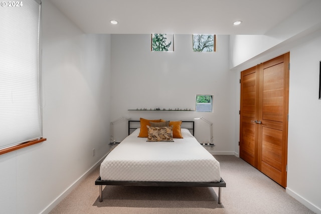 bedroom with recessed lighting, baseboards, and light carpet