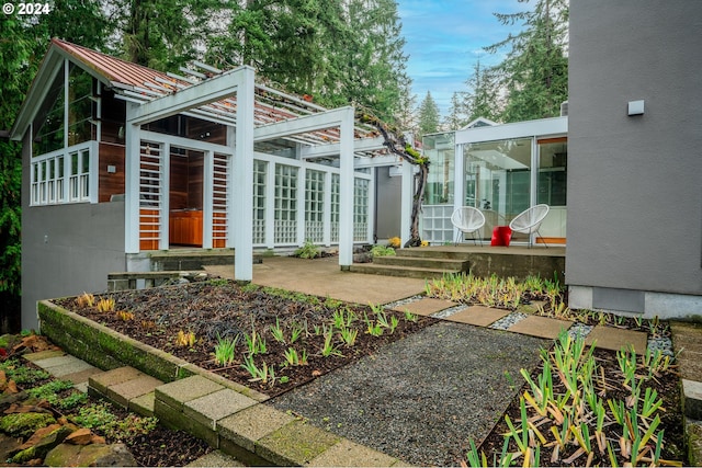 exterior space featuring a patio area and a sunroom