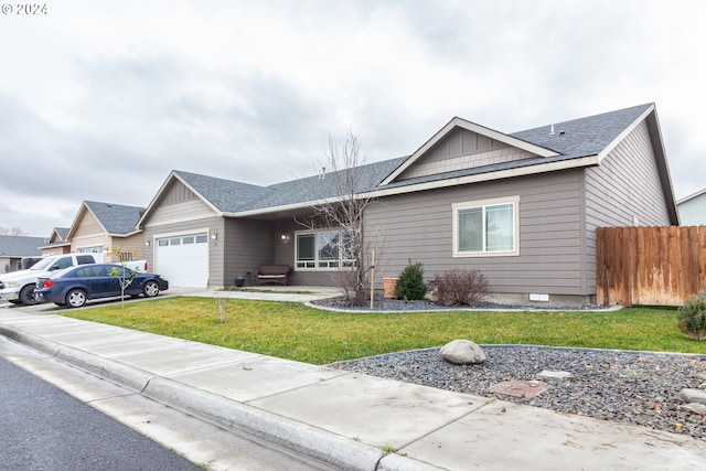 ranch-style house with a garage and a front yard