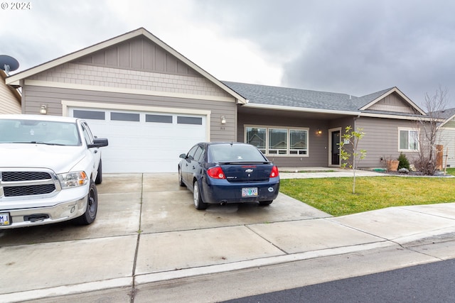 single story home featuring a garage and a front lawn