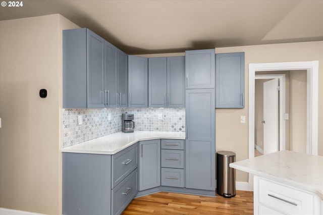 kitchen featuring decorative backsplash and light wood-type flooring