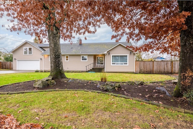 ranch-style home with a garage and a front lawn