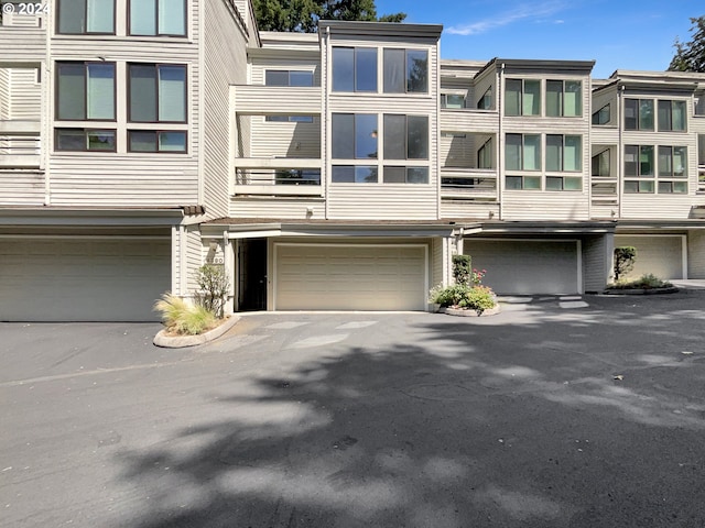 view of property featuring a balcony and a garage