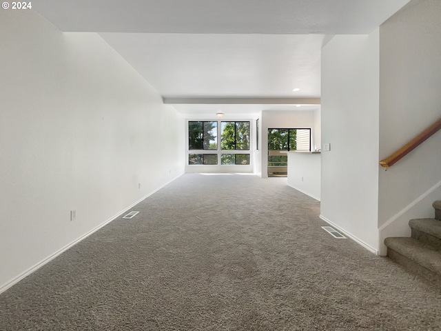 unfurnished living room featuring carpet floors