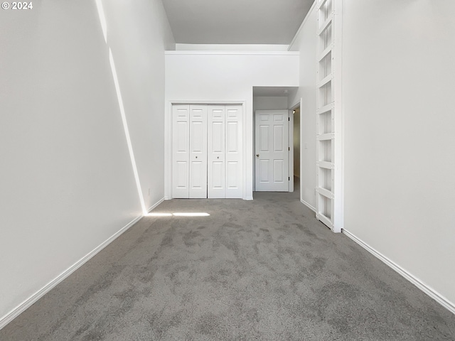 unfurnished bedroom with a closet and carpet flooring