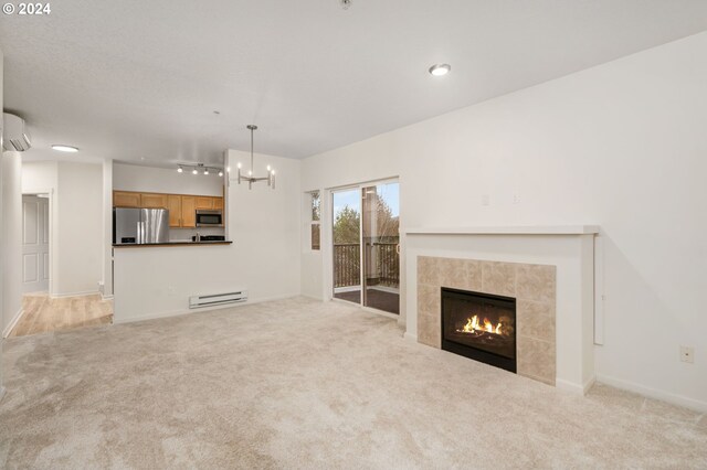 unfurnished living room featuring a tiled fireplace and light colored carpet