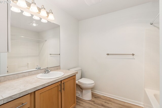 bathroom with hardwood / wood-style flooring and walk in shower