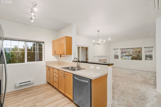 kitchen featuring a sink, open floor plan, dishwasher, a peninsula, and a baseboard radiator