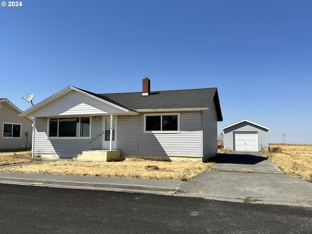 ranch-style house with a garage and an outbuilding