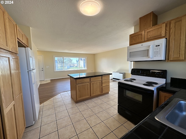 14865 Mt View Dr, Condon, OR 97823 - kitchen with a textured ceiling, light tile patterned floors, a sink, and white appliances