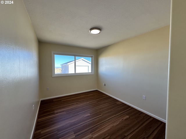 14865 Mt View Dr, Condon, OR 97823 - spare room featuring dark wood-type flooring, a textured ceiling, and baseboards