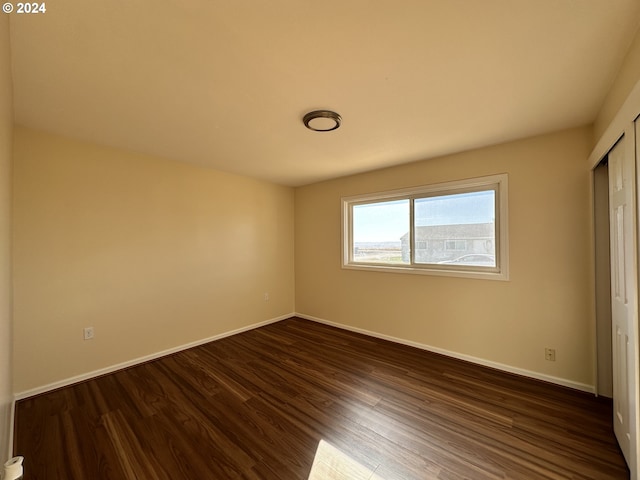 14865 Mt View Dr, Condon, OR 97823 - unfurnished bedroom featuring a closet, baseboards, and dark wood finished floors