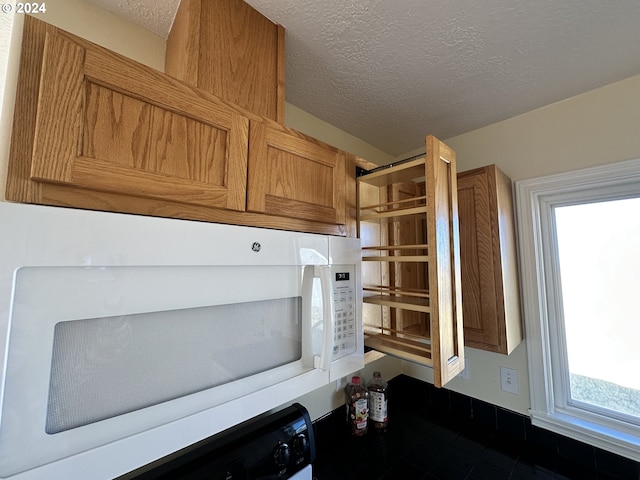 14865 Mt View Dr, Condon, OR 97823 - details featuring brown cabinets, white microwave, and a textured ceiling