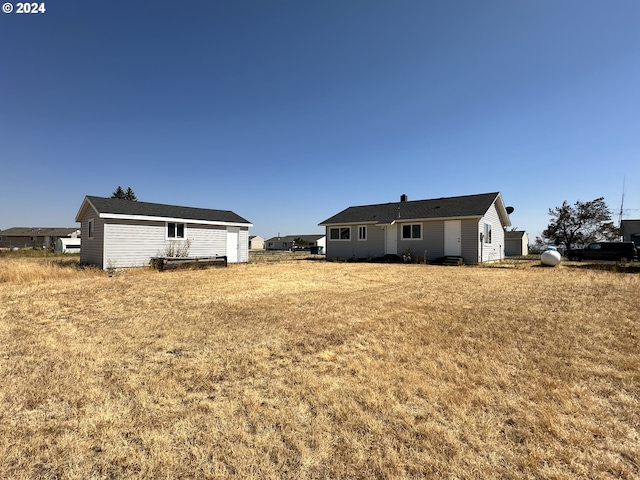 rear view of property featuring a yard