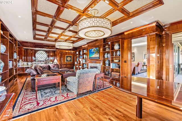 living room featuring beam ceiling, wooden walls, hardwood / wood-style flooring, and coffered ceiling