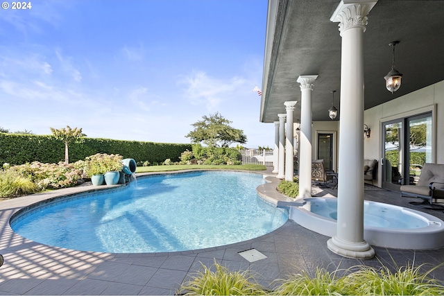 view of pool with pool water feature and a patio