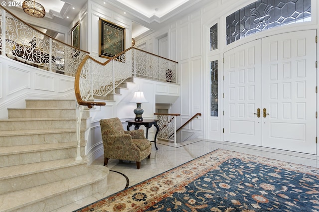 foyer with a high ceiling and ornamental molding