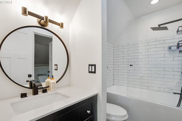 full bathroom featuring tiled shower / bath combo, vanity, and toilet