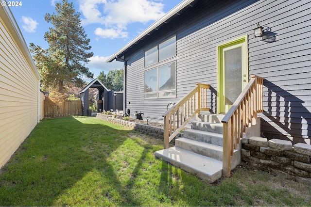 entrance to property with a lawn