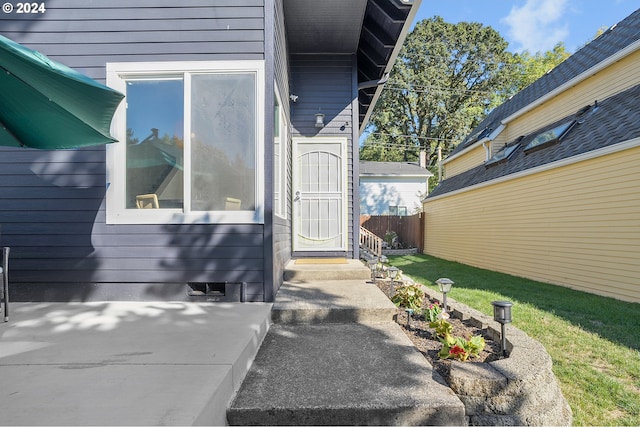 doorway to property with a lawn