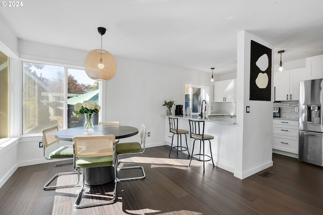 dining area featuring dark hardwood / wood-style flooring