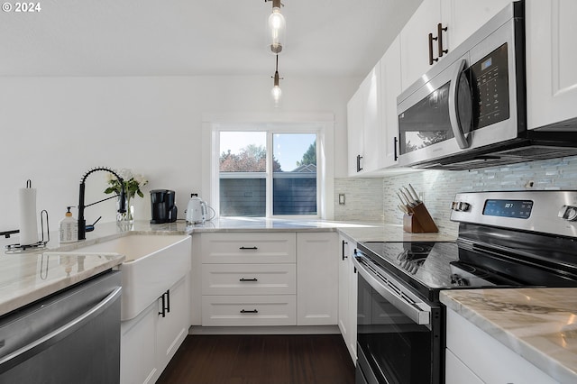 kitchen featuring decorative backsplash, white cabinets, dark hardwood / wood-style flooring, appliances with stainless steel finishes, and decorative light fixtures