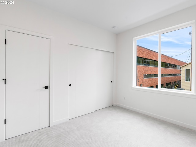 unfurnished bedroom with light colored carpet