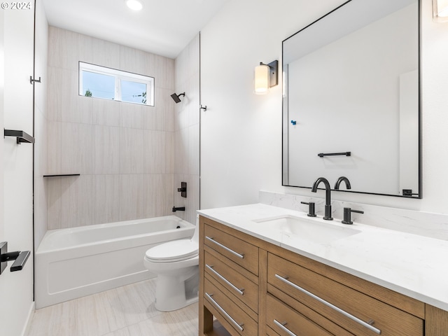 full bathroom featuring tiled shower / bath, vanity, and toilet