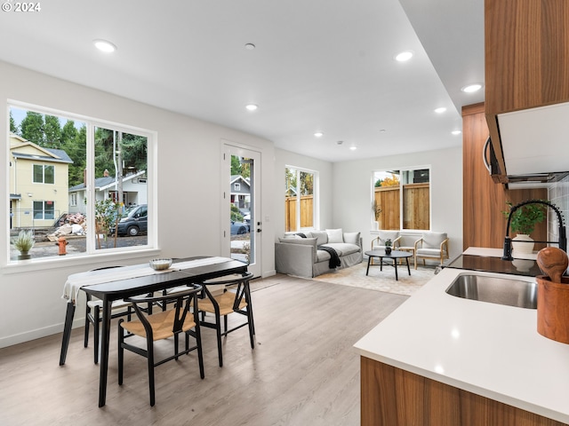 dining space featuring plenty of natural light, light hardwood / wood-style floors, and sink