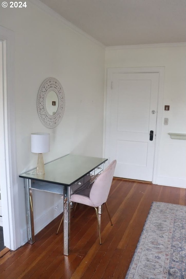 dining room with crown molding and dark hardwood / wood-style flooring