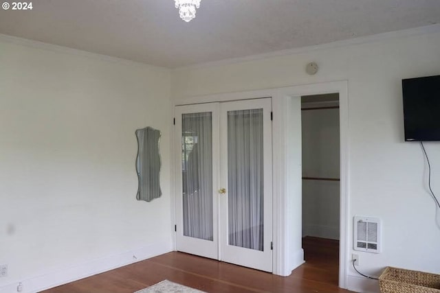 unfurnished bedroom featuring dark hardwood / wood-style flooring and french doors