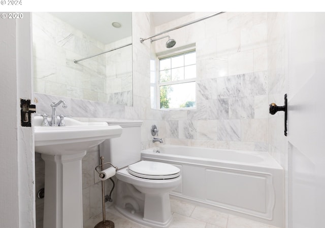 full bathroom featuring sink, tile walls, tiled shower / bath combo, tile patterned flooring, and toilet