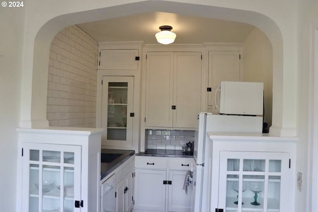 kitchen with white cabinets, dishwasher, and decorative backsplash