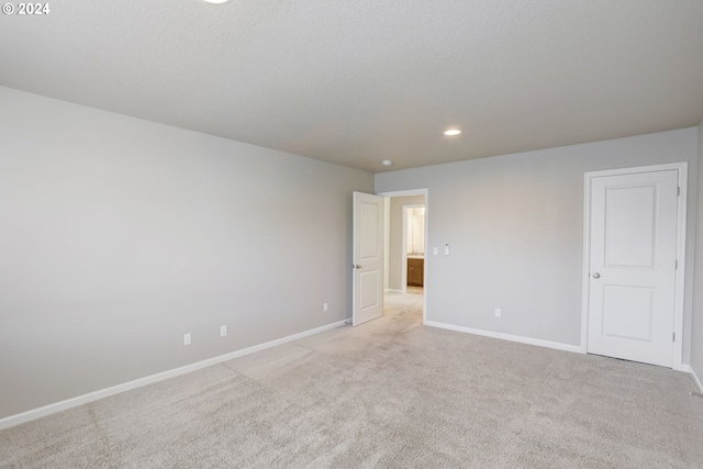 unfurnished room with light carpet