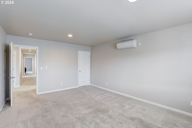 carpeted empty room with an AC wall unit