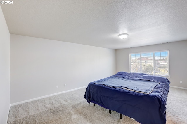 carpeted bedroom featuring a textured ceiling