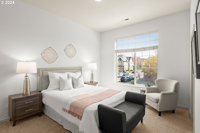 bedroom with light colored carpet