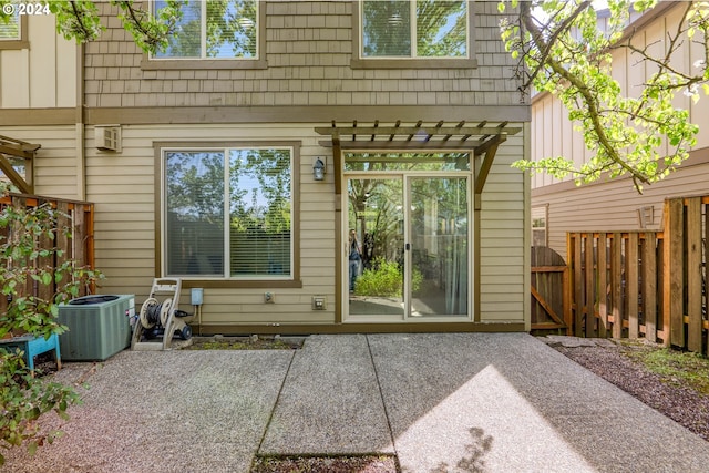 property entrance with central air condition unit and a patio area