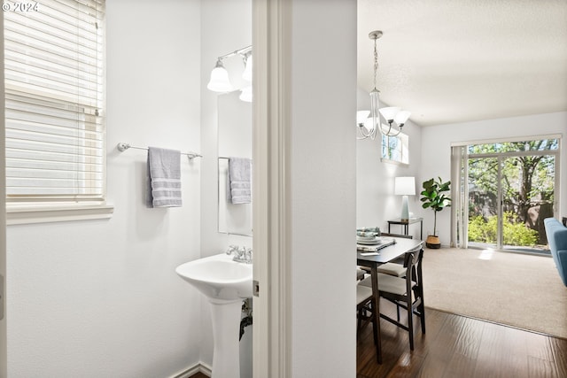 bathroom featuring sink, hardwood / wood-style floors, and an inviting chandelier