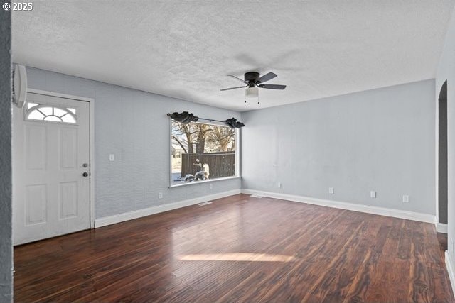 entrance foyer with ceiling fan, dark hardwood / wood-style flooring, and a textured ceiling