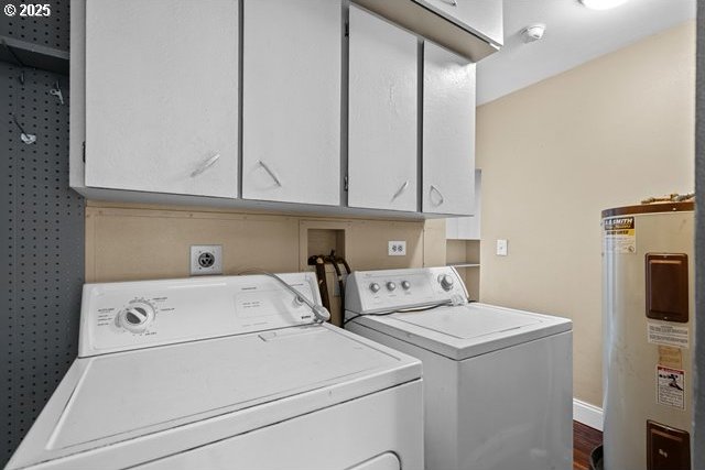 laundry room featuring water heater, separate washer and dryer, and cabinets