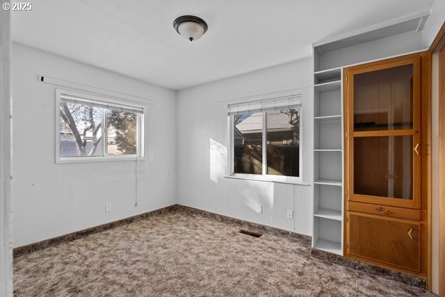 unfurnished room featuring carpet flooring