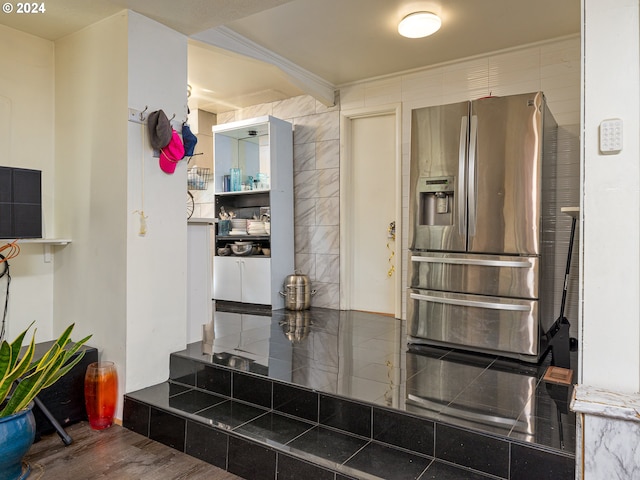 kitchen featuring ornamental molding, stainless steel fridge, and hardwood / wood-style floors